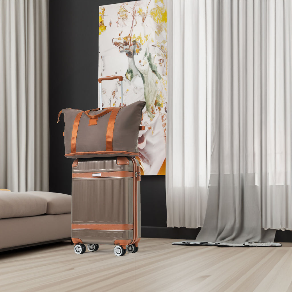 Coppery carry-on suitcase with top handle and two spinner wheels, plus matching duffel bag
