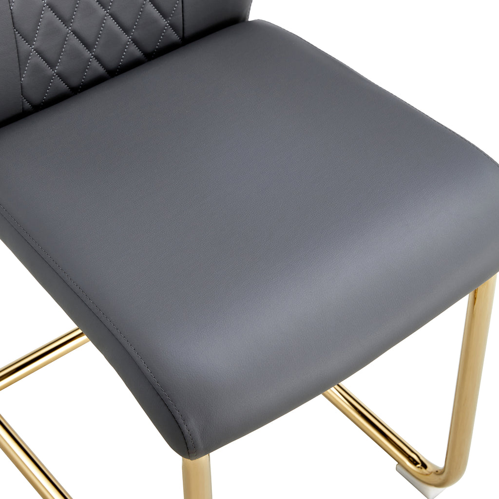 Close-up of gray cushioned seat on gold metal chair legs