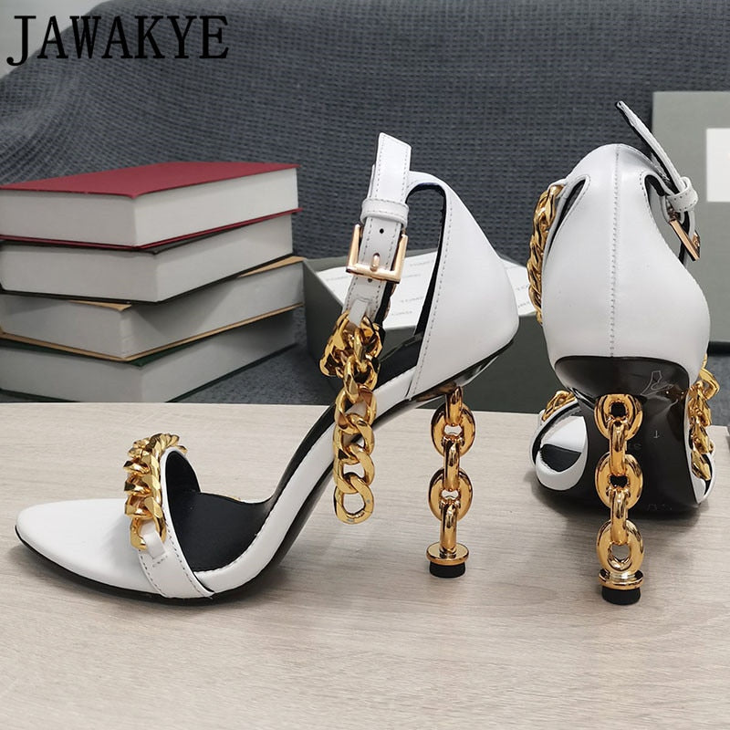 Pair of white ankle-strap high heels with gold chain links and stiletto heel