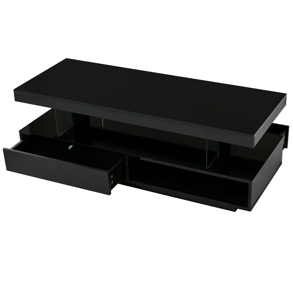 Black coffee table with open drawers revealing storage compartments underneath.