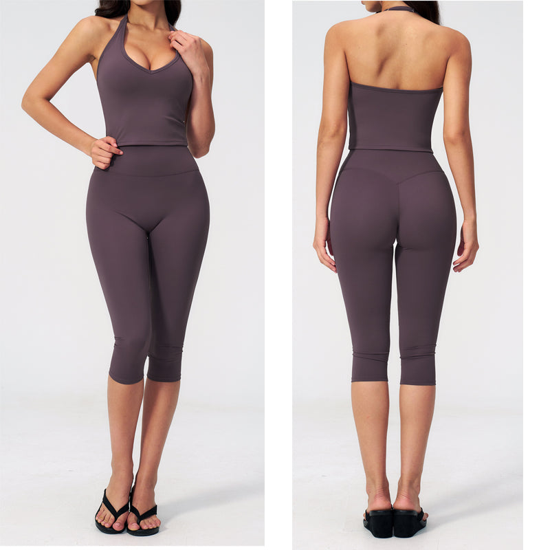 Women’s sports vest suit in aubergine purple: sleeveless crop top and capri leggings.