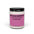 Scented soy candle in clear glass jar with black screw lid, purple label