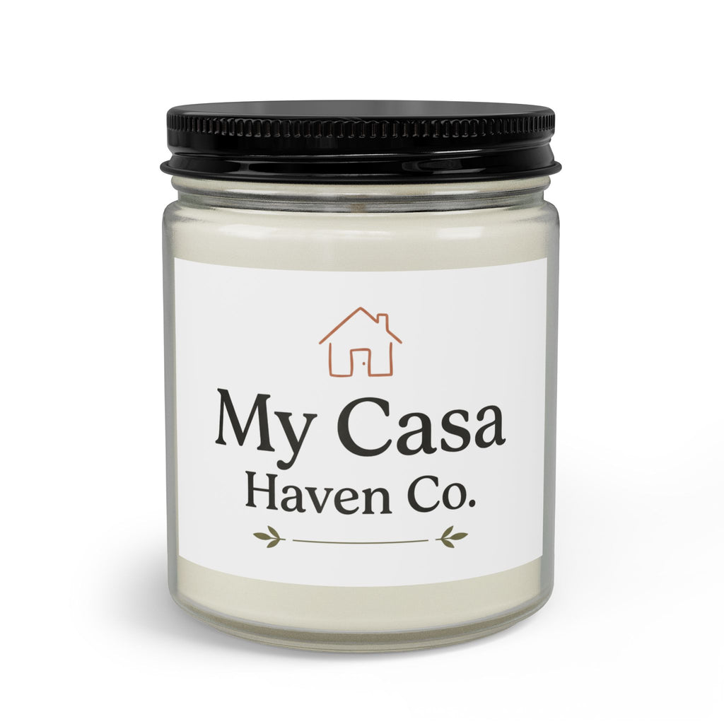 Candle jar with black lid, pale cream wax, clear glass body and printed house label