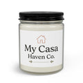 Candle jar with black lid, pale cream wax, clear glass body and printed house label