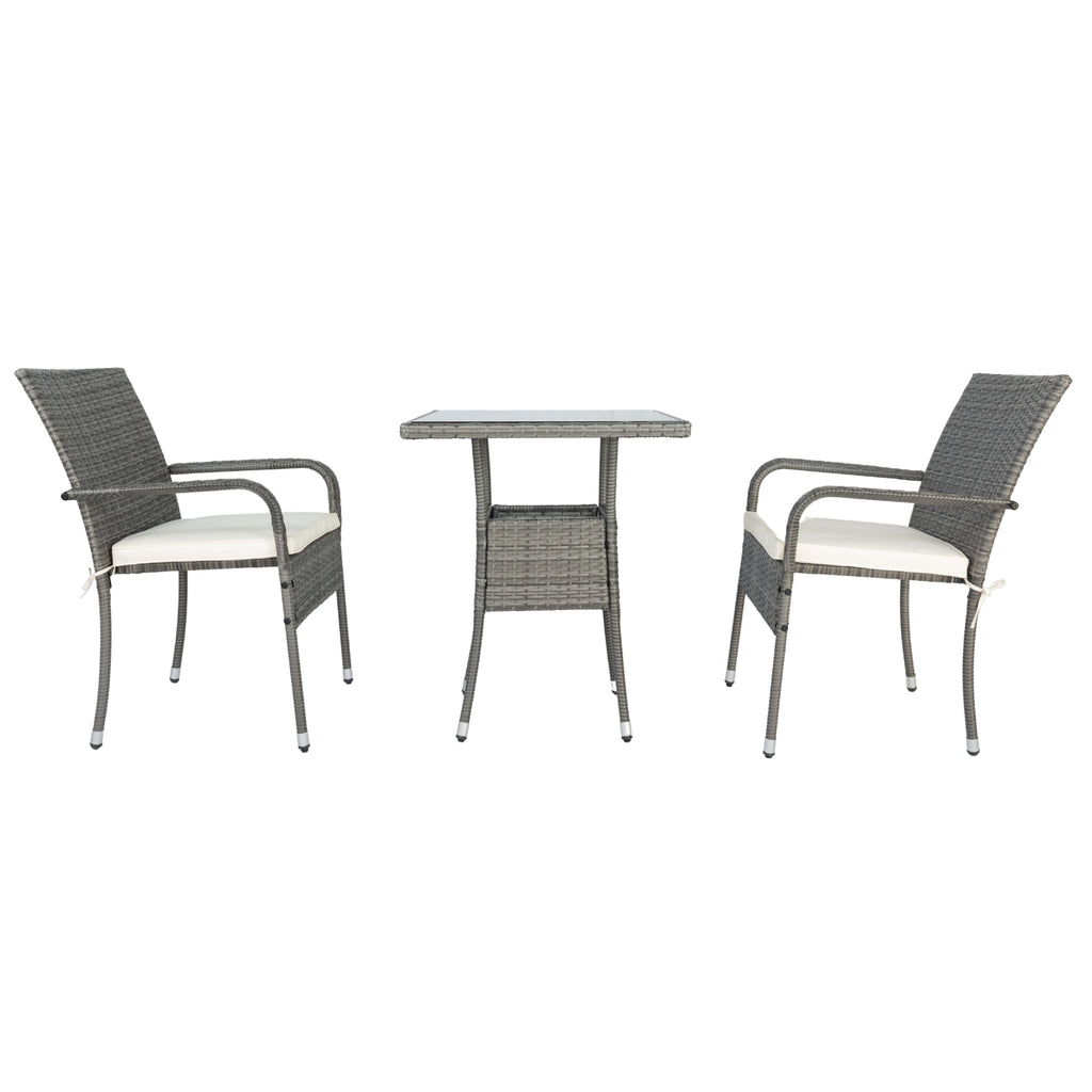 Grey wicker conversation set with two armchairs, white cushions, and glass-top side table