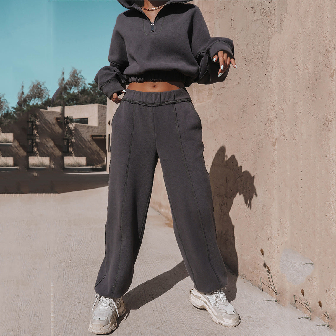 Charcoal jogger pants with elastic waist and cuffed hem, paired with half-zip hoodie