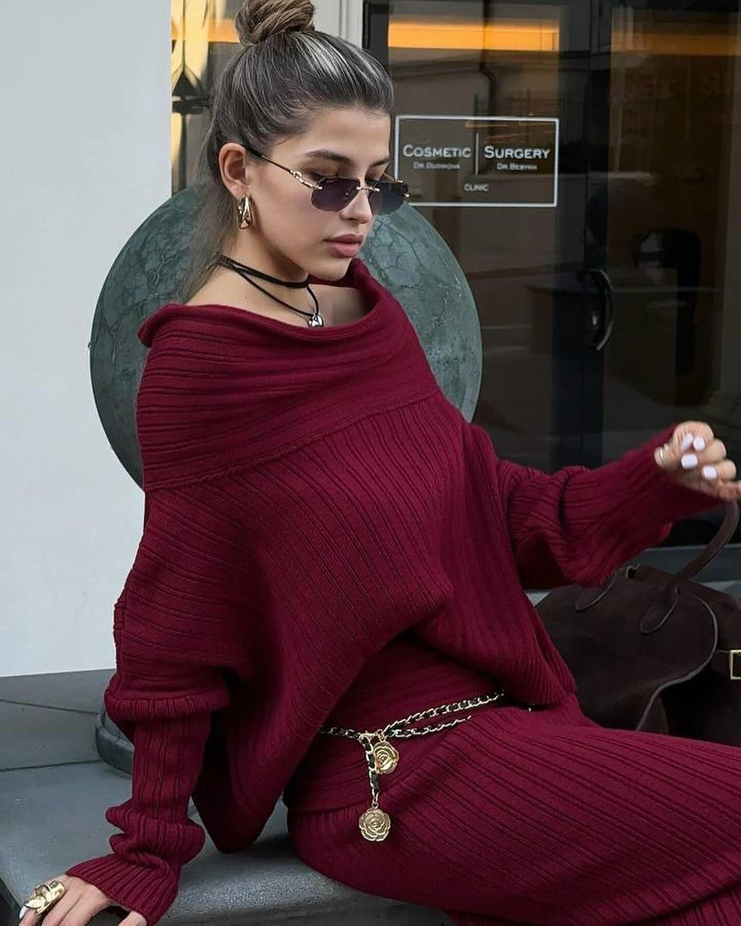 Burgundy off-shoulder ribbed knit sweater with matching long skirt set, close-up