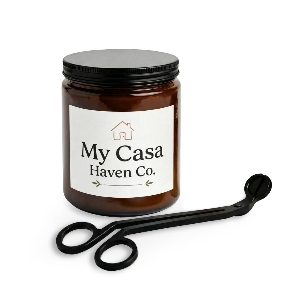 Glass candle jar with amber wax and black lid, plus black wick trimmer tool