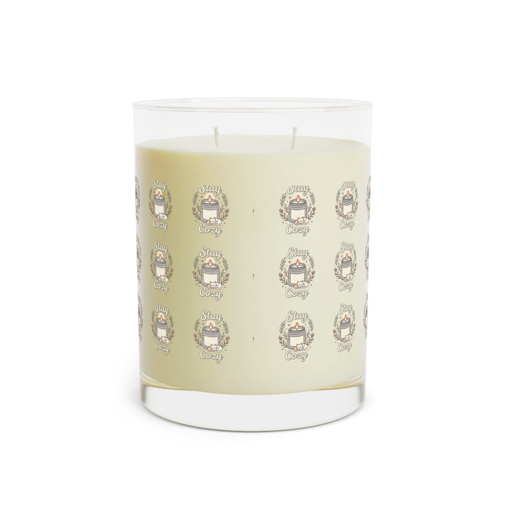 Clear glass candle with cream wax and repeating Cozy emblem label pattern