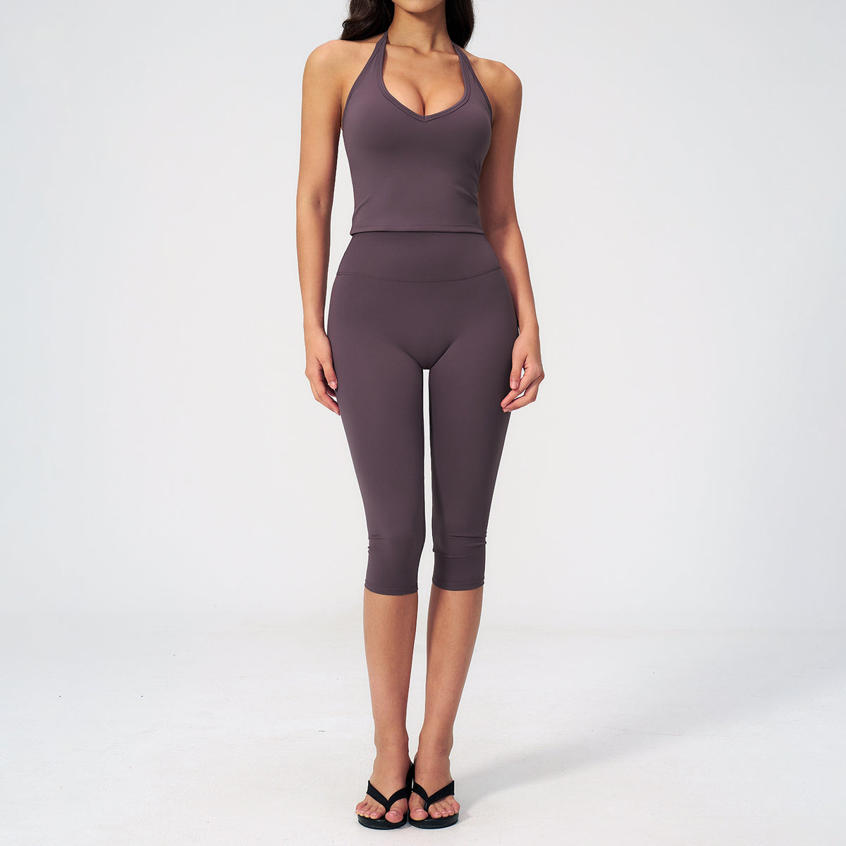 Women’s sports vest suit in aubergine purple: front view sleeveless crop top and capris.