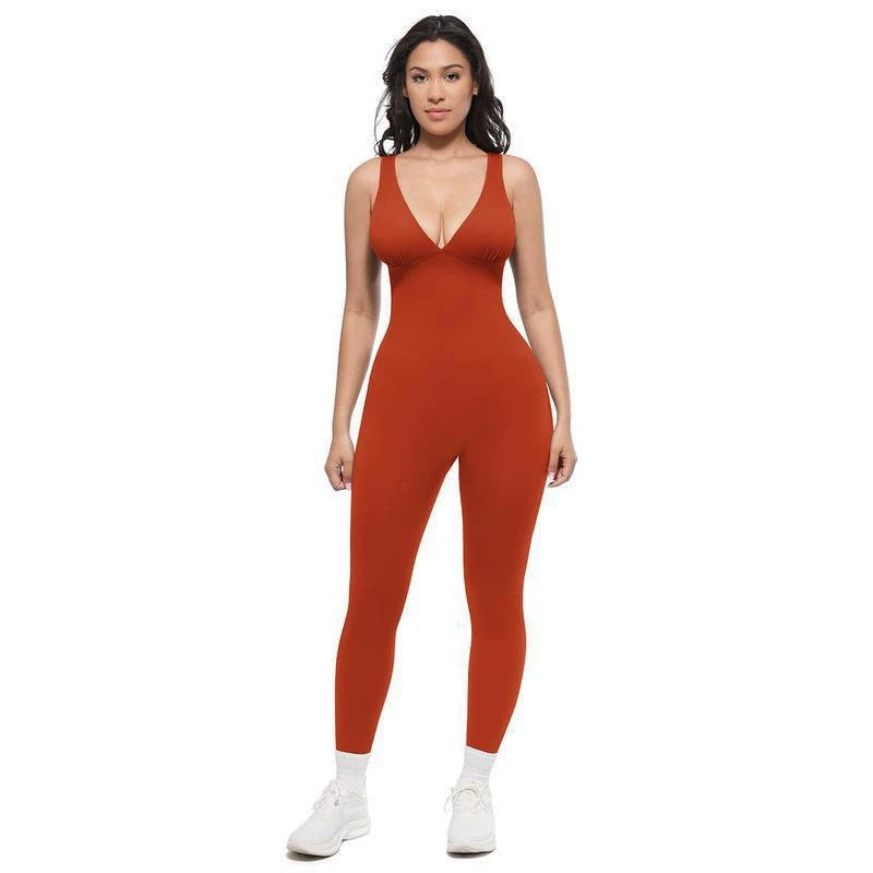 Red women's sleeveless V-neck jumpsuit with long fitted legs, front standing pose