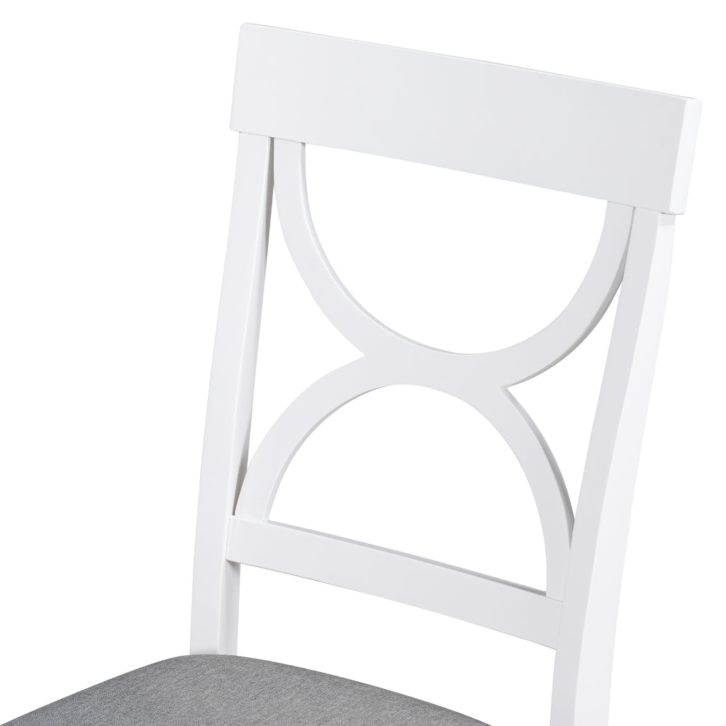 White dining chair with scalloped back design, showing gray upholstered seat edge