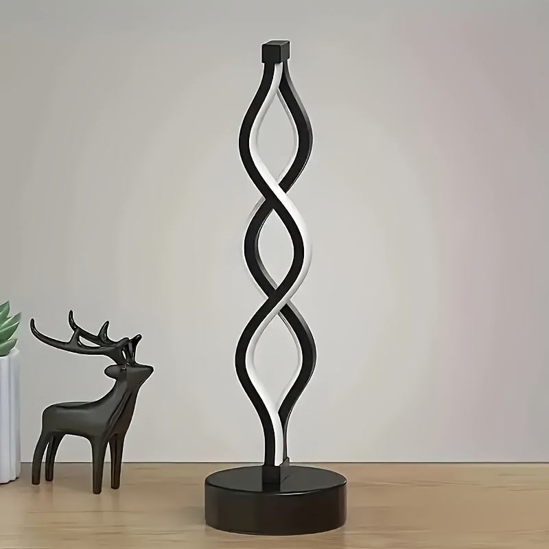 Black loop bar table lamp with round base, bright white LED glow
