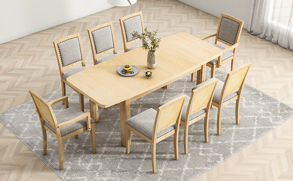 Corner view of natural wood dining table with eight upholstered chairs