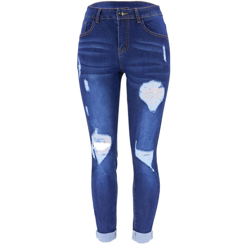 Dark blue women's jeans with large knee rips and frayed distressed holes