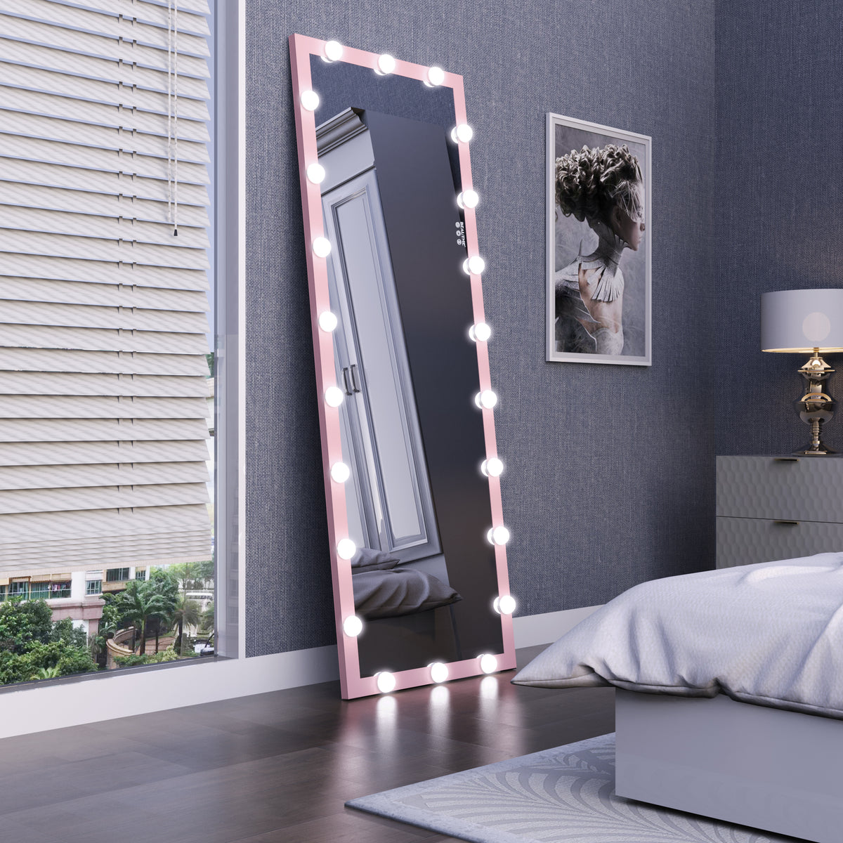 Pink illuminated full-length mirror standing in a bedroom with bulb border