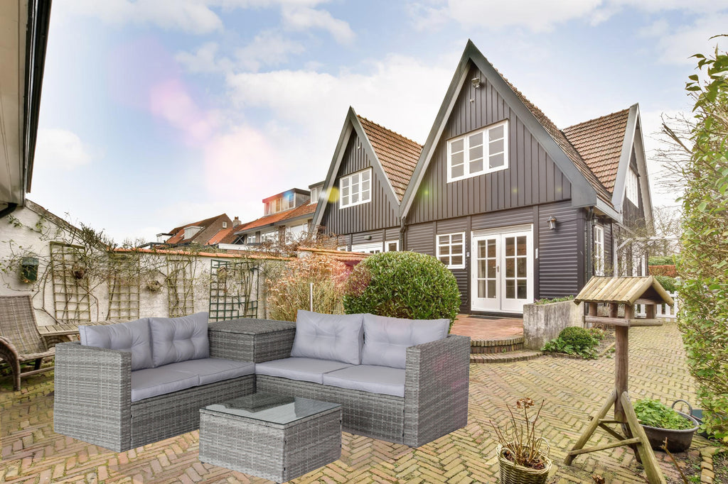Grey wicker patio sectional sofa set with light cushions and glass-top storage ottoman in garden