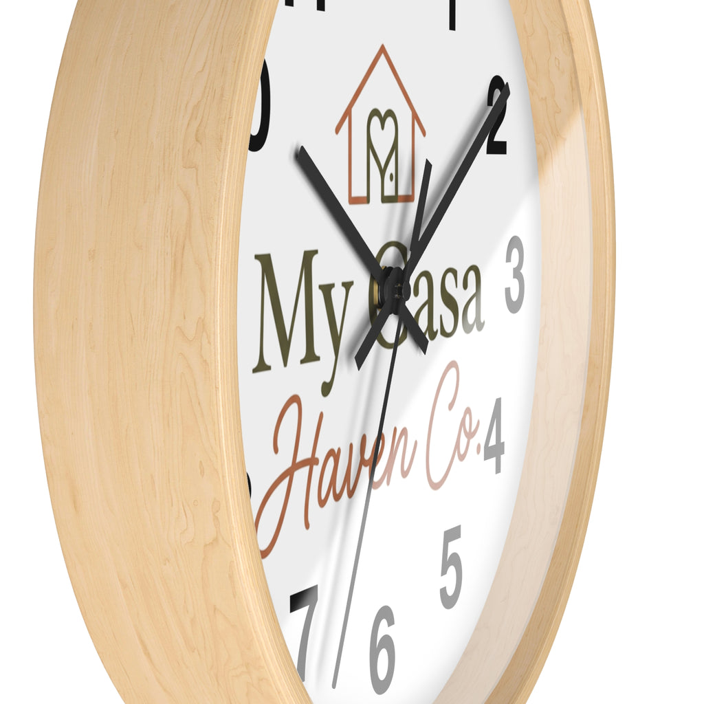 Wood wall clock with light wood frame, angled view of numbered white face and black hands