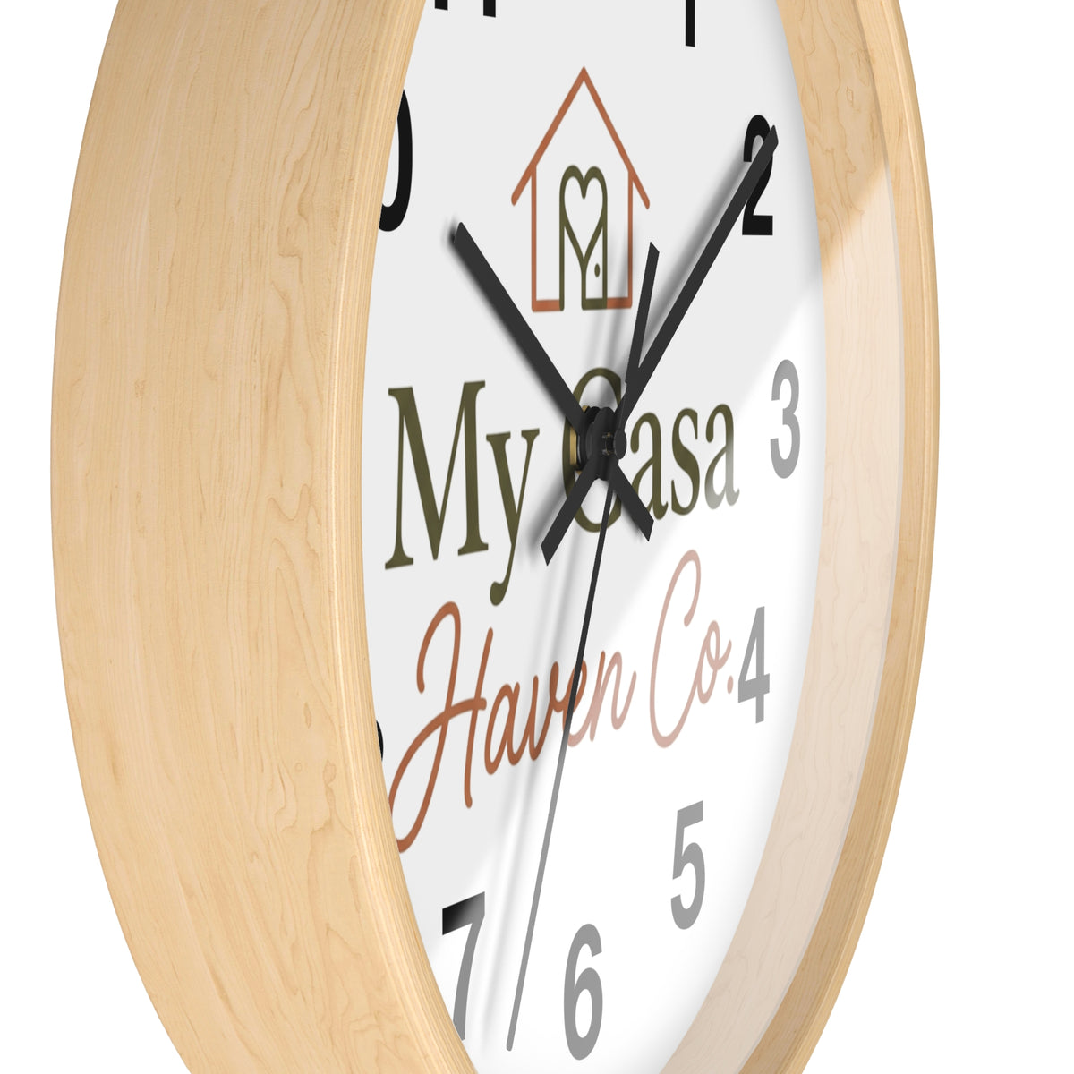 Wood wall clock with light wood frame, angled view of numbered white face and black hands