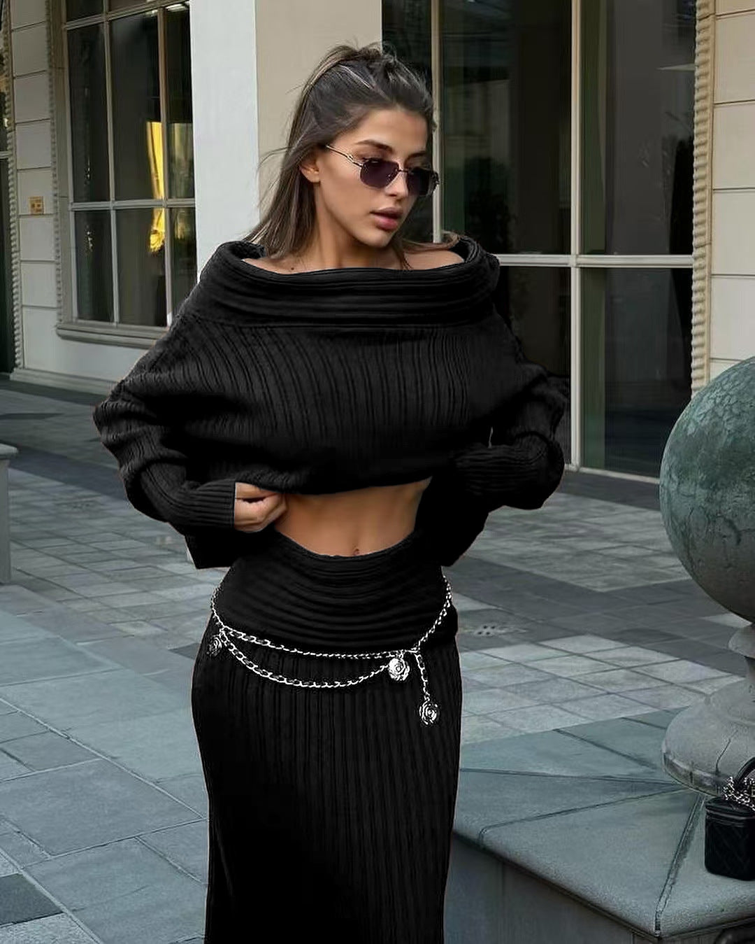 Black off-shoulder ribbed knit sweater with matching long knit skirt set