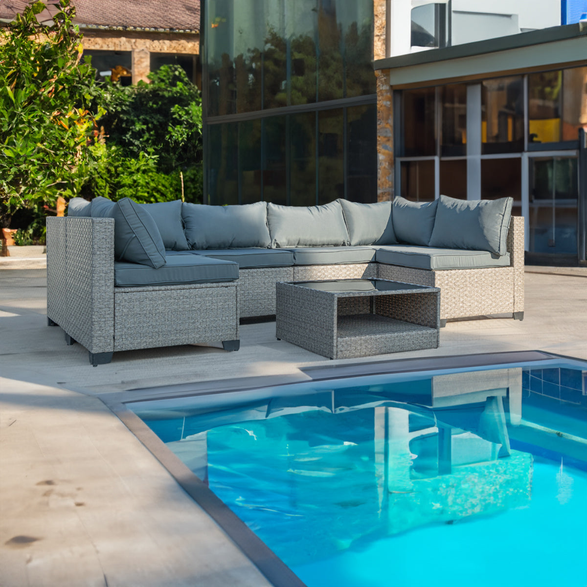 Grey outdoor sectional sofa with thick blue-gray cushions and beige woven rattan frame
