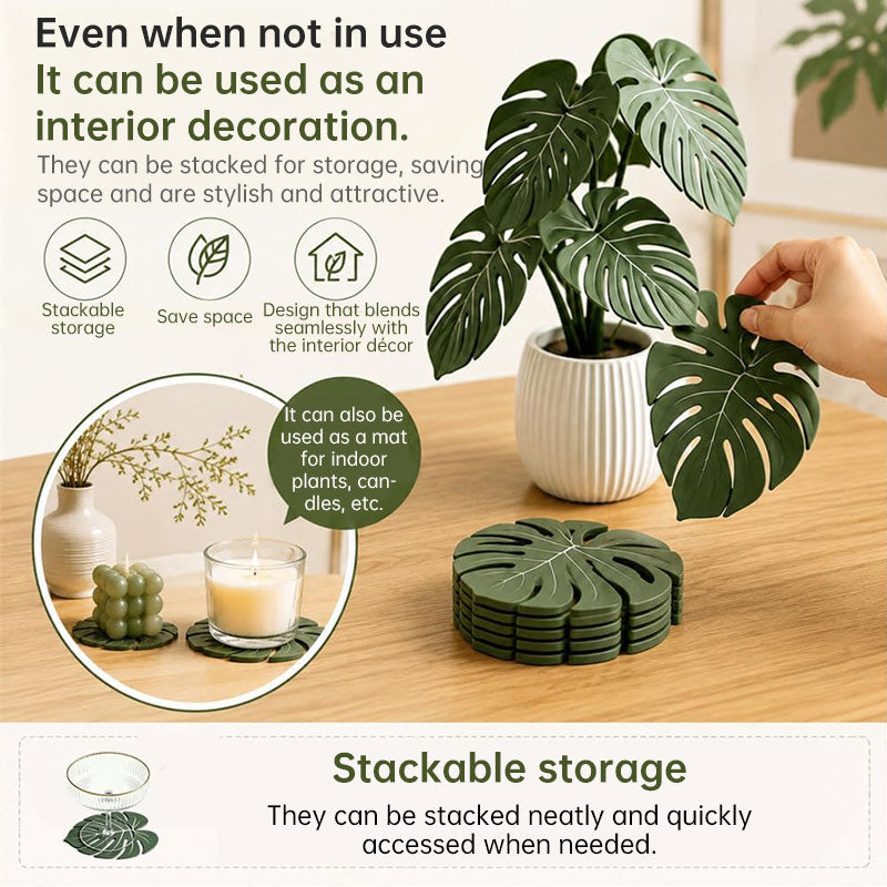 Stackable green monstera leaf coasters with detachable blades on a wooden surface