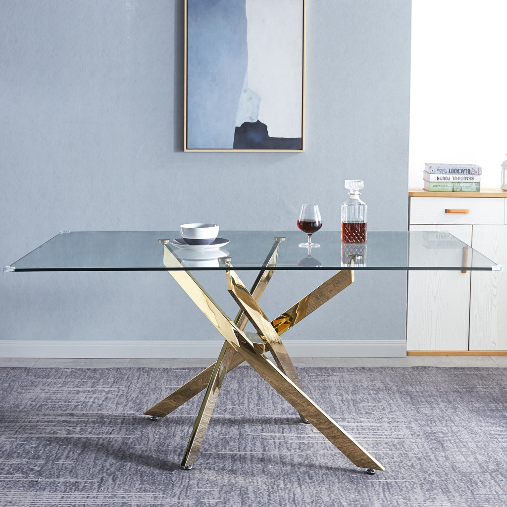Rectangular glass dining table, clear tempered top with gold cross legs.