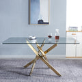 Rectangular glass dining table, clear tempered top with gold cross legs.