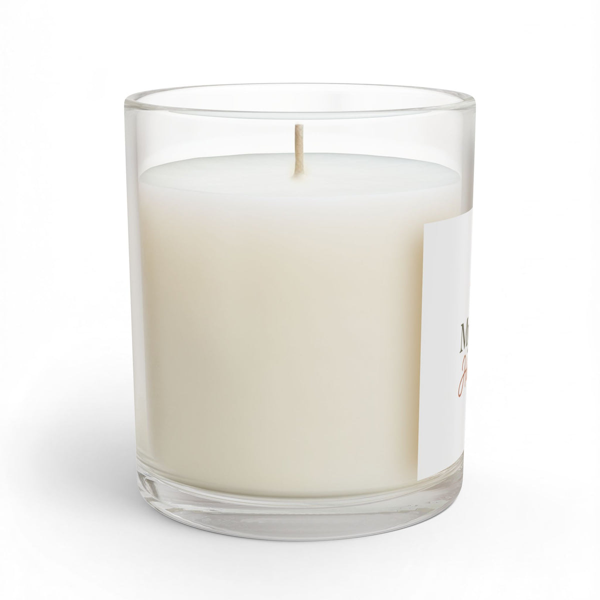 Glass candle in clear jar with creamy white wax and lit wick