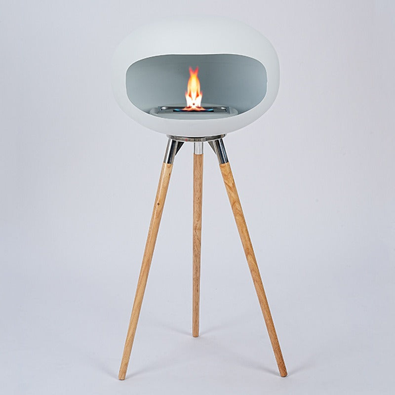 Light gray round ethanol fire bowl with small flame on tray, three wood tripod legs.