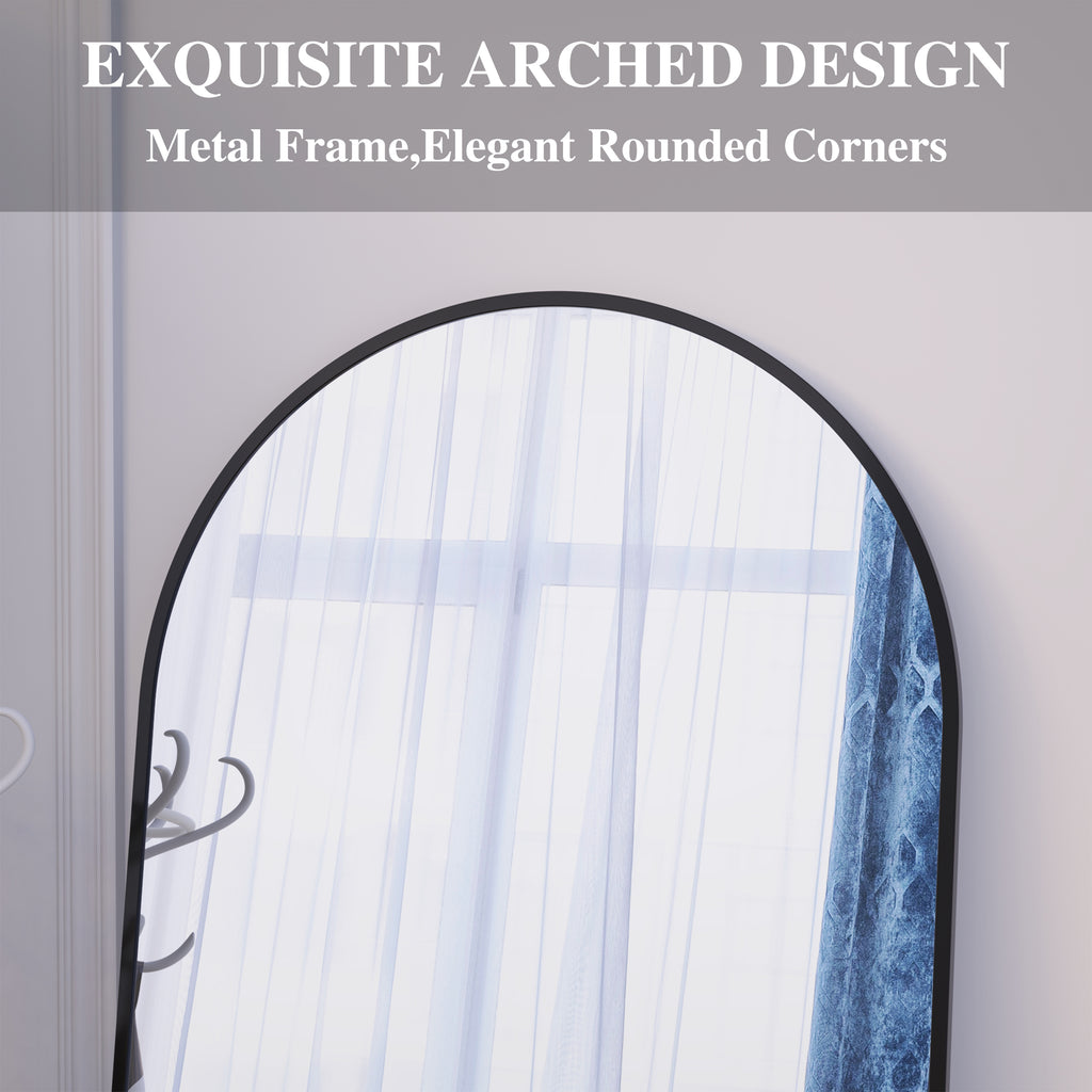 Arched floor mirror close-up with black metal frame and rounded corners.