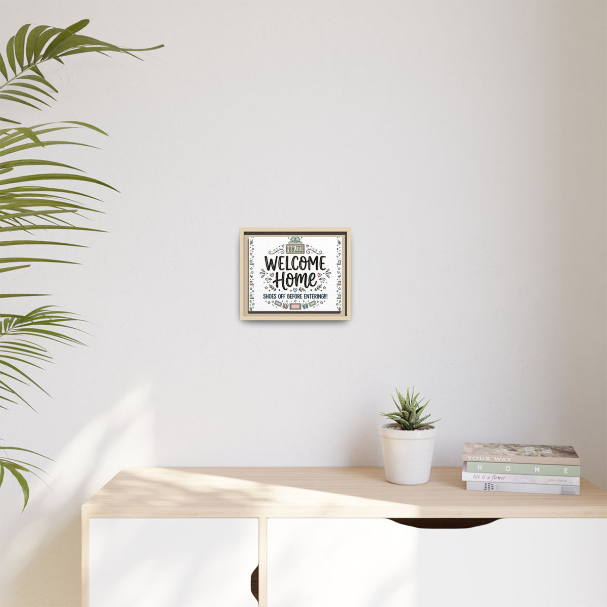 Wall-mounted framed matte canvas showing “Welcome Home” and “Shoes off before entering”.
