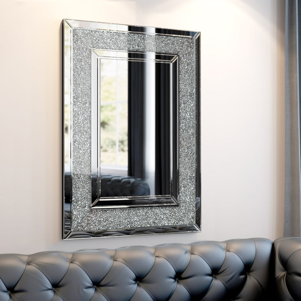 Silver rectangular wall mirror with textured frame and reflective glass panel