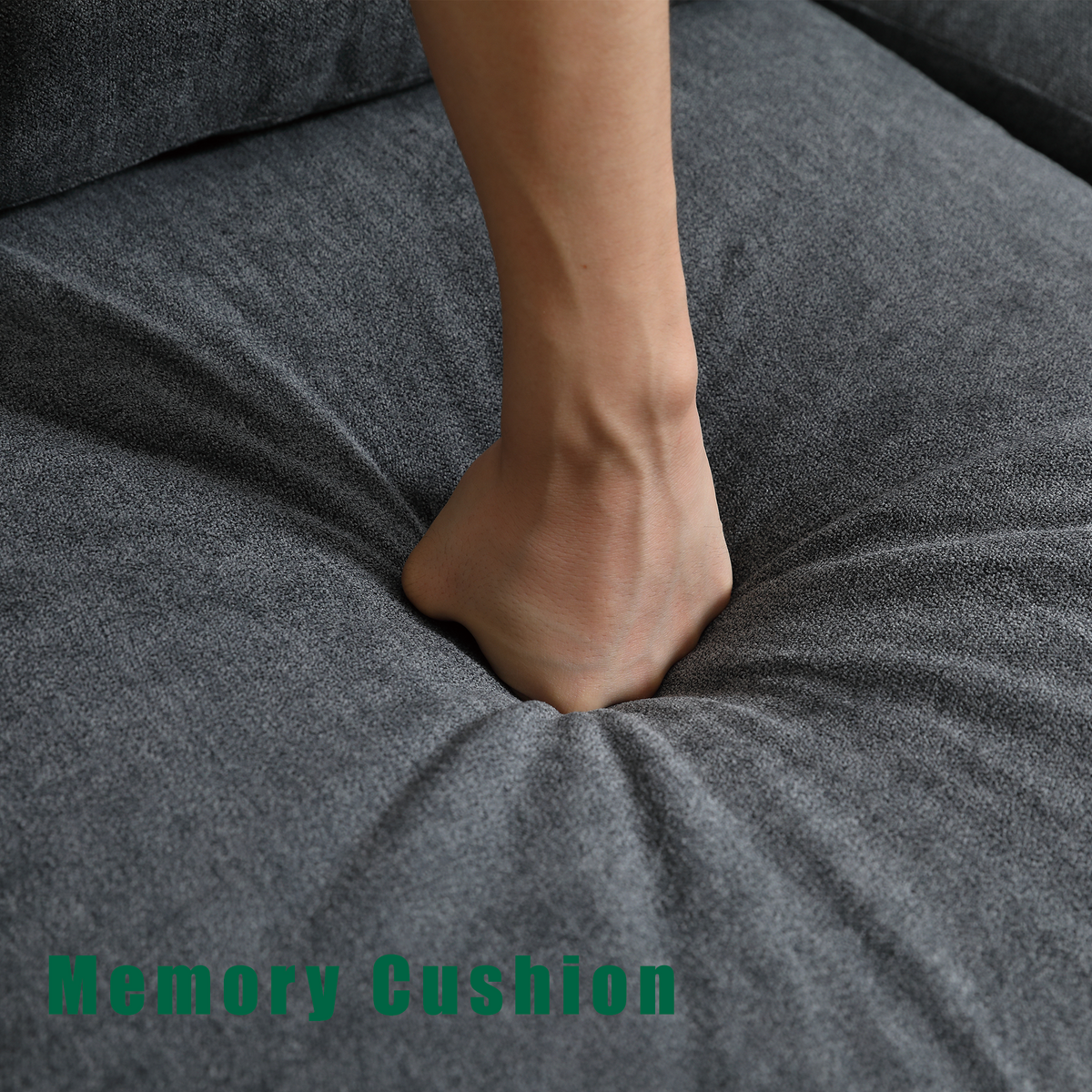 Gray upholstered seat cushion with a person’s foot resting on the fabric