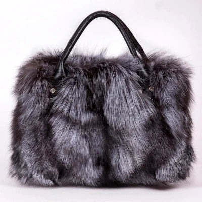 Dark gray faux fur handbag with black leather handles and front silver studs