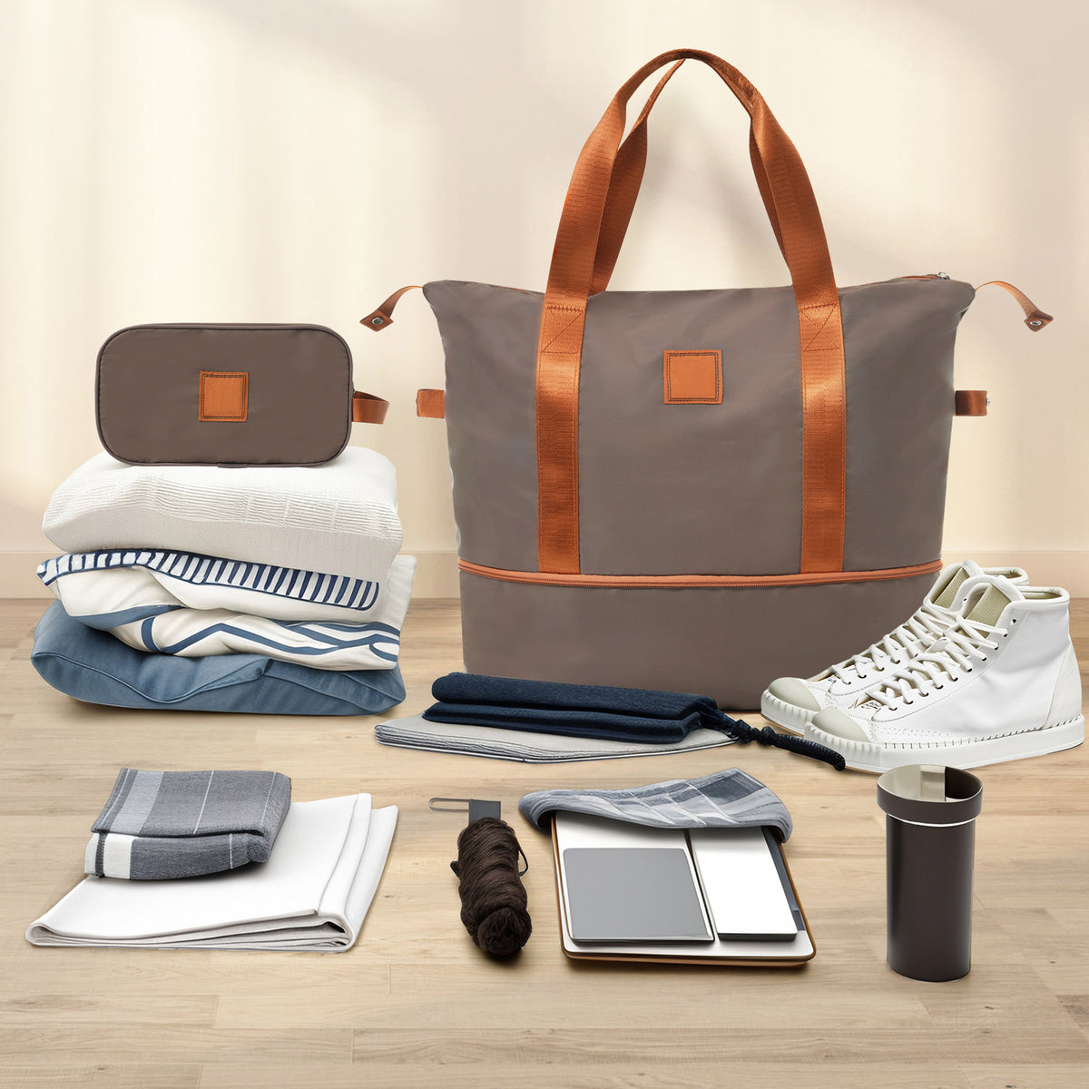 3-piece luggage set with coppery duffel bag, gray duffel, and packed travel essentials