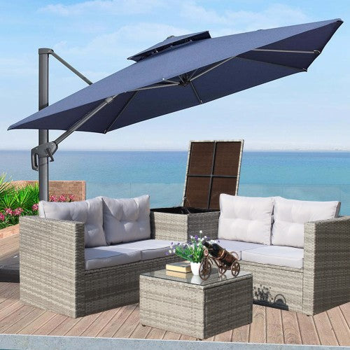 Grey outdoor sectional sofa set with white cushions and open umbrella
