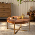 Round fir wood coffee table with gold legs and tabletop display items
