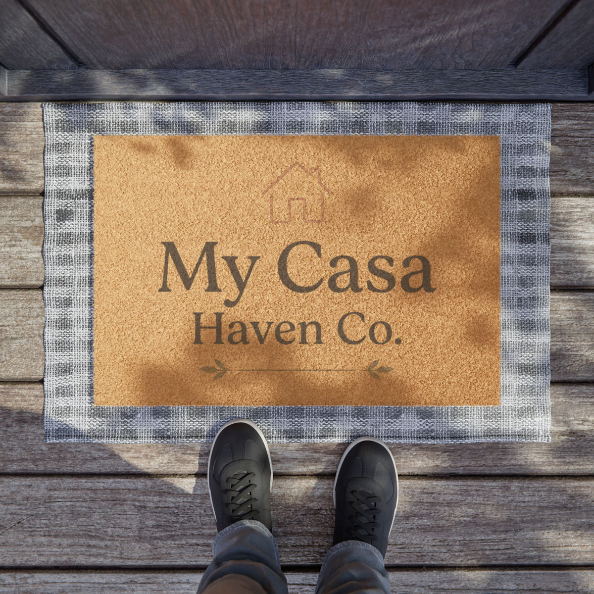 Tan coir doormat with 'My Casa Haven Co.' print and gray check border