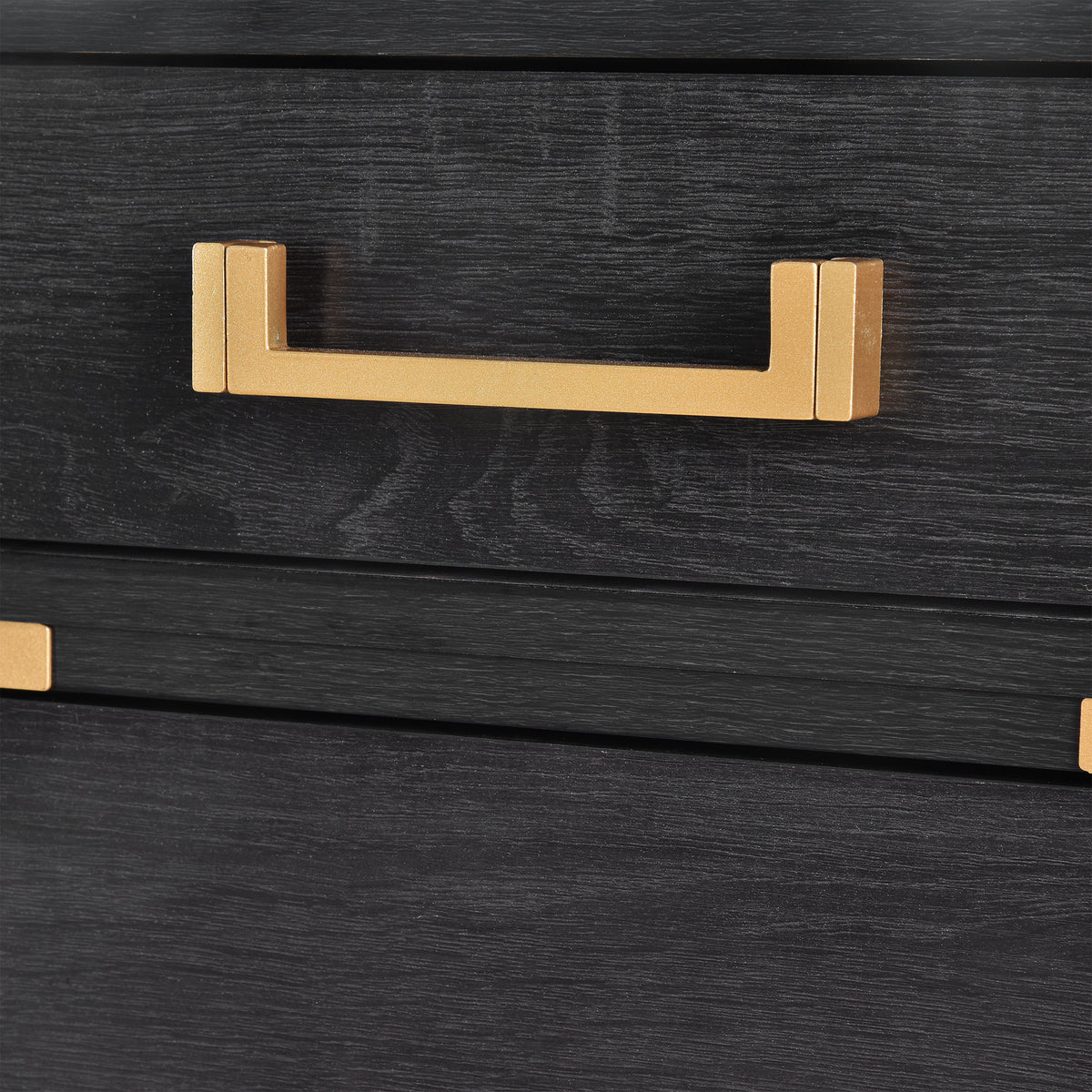 Gold drawer handle on dark black file drawer front