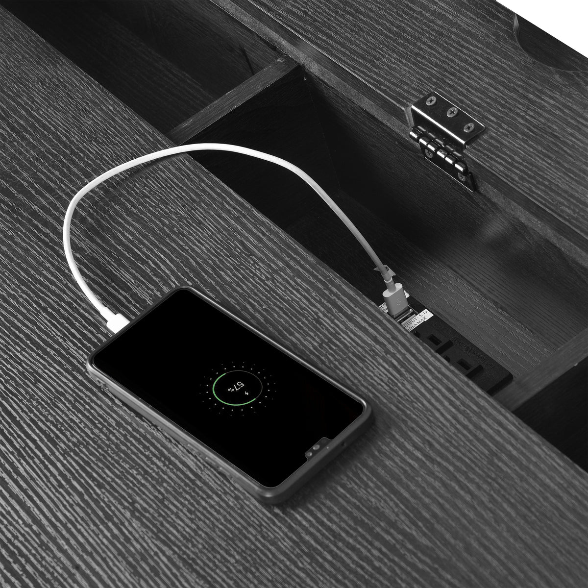 Open desk cable area with black device holder and ports panel