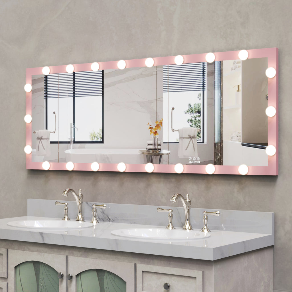 Pink Hollywood vanity mirror with illuminated bulbs mounted above a bathroom sink