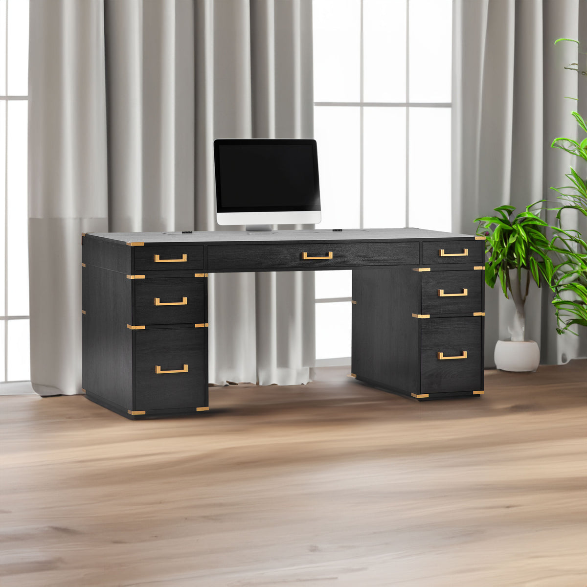 Black desk with gold metal trim, two file drawers, and drawer pulls