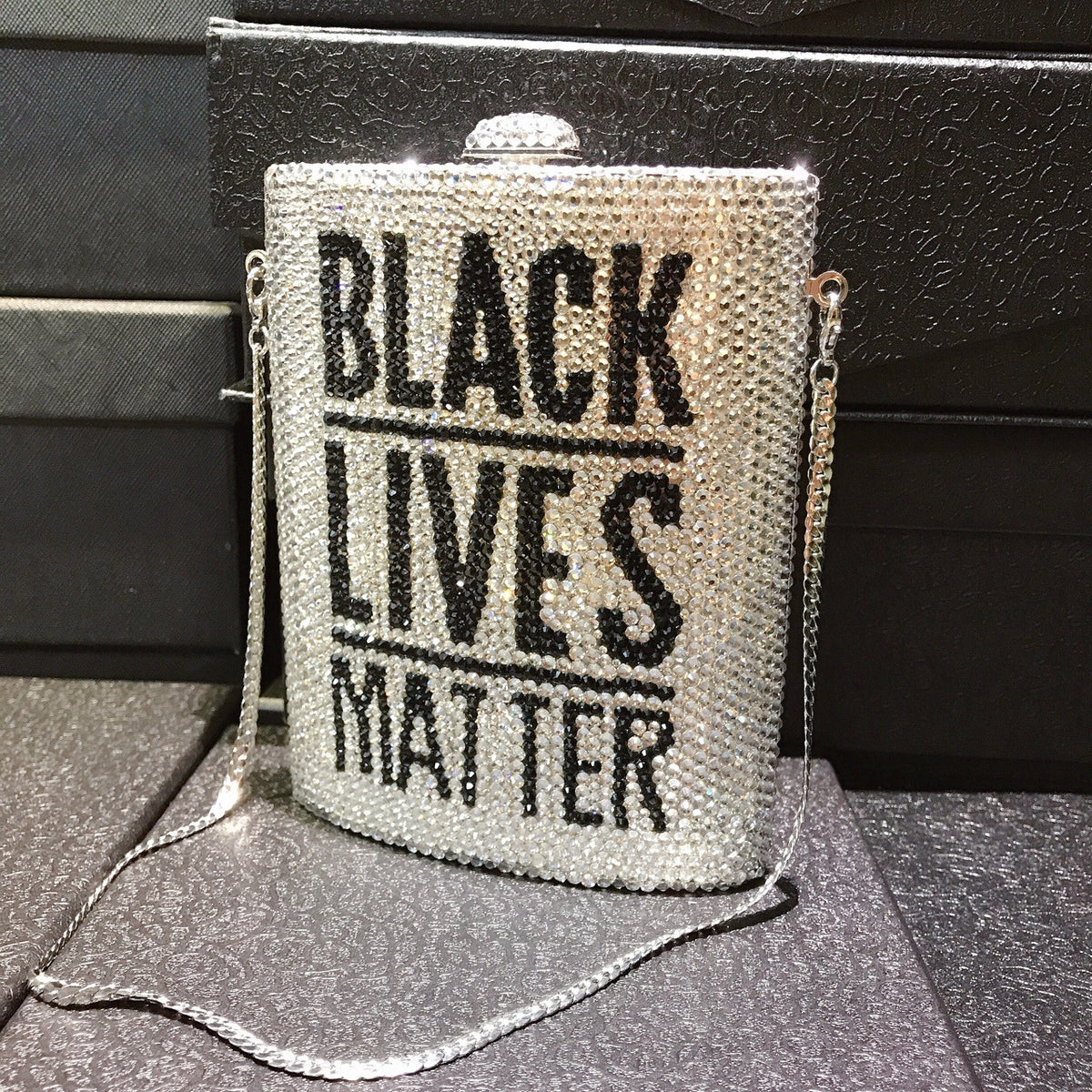 Silver rhinestone crossbody bag with chain, front text “BLACK LIVES MATTER”