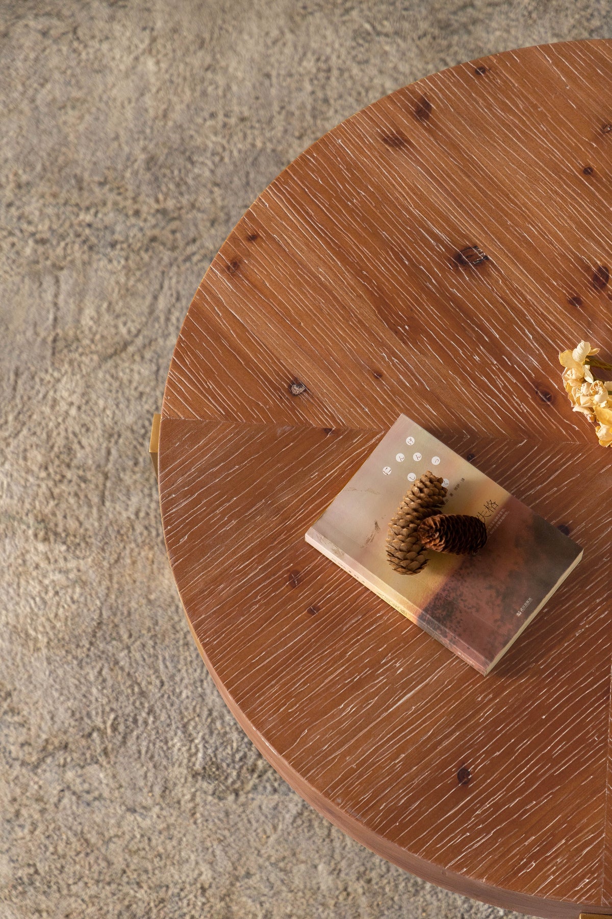 Round fir wood tabletop with visible grain and decorative items near the edge