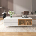 White coffee table with two glass doors, ribbed sides, gold legs, drawer fronts