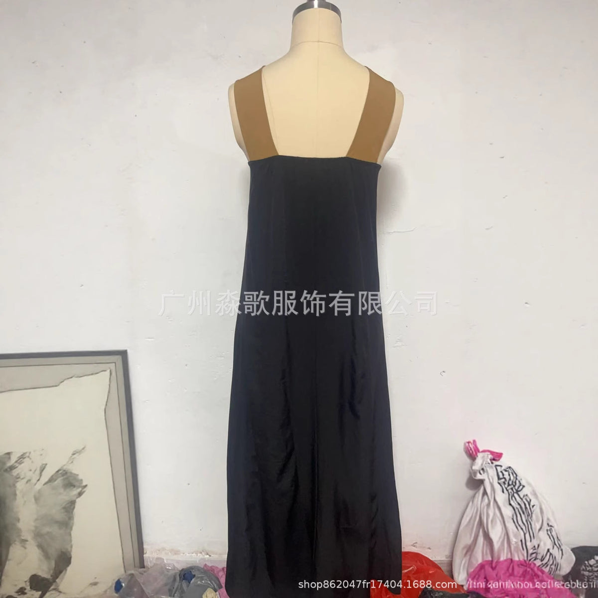 Black sleeveless cross-strap maxi dress on mannequin, V back with crisscross straps