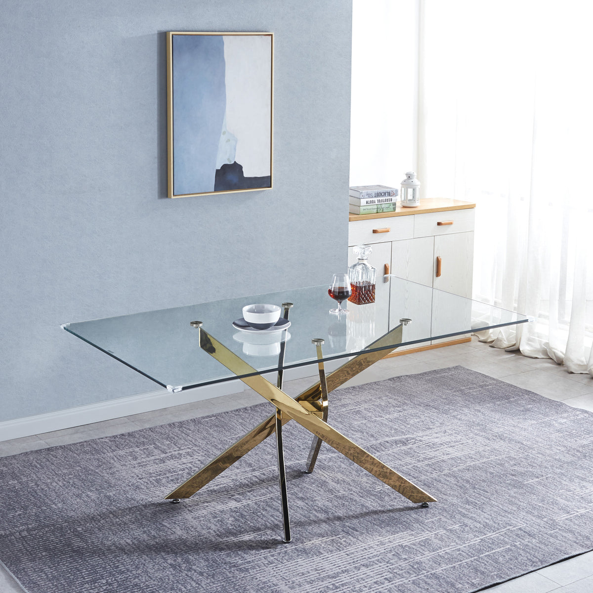 Rectangular tempered glass dining table with gold X base and transparent tabletop.