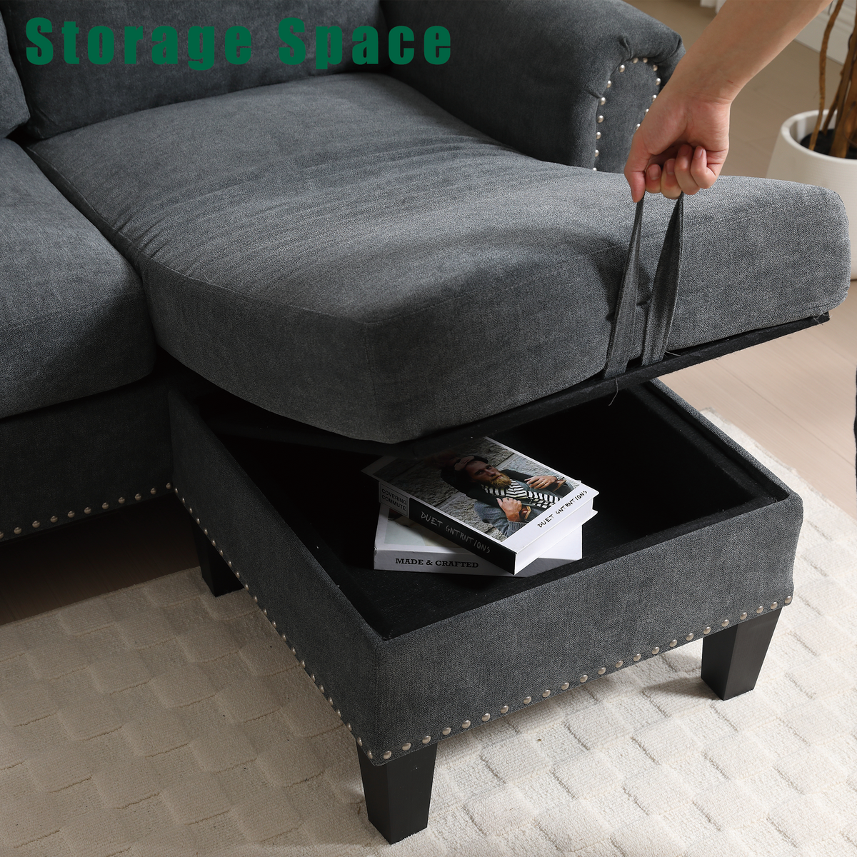 Gray storage ottoman with open compartment under chaise, black legs and nailhead trim