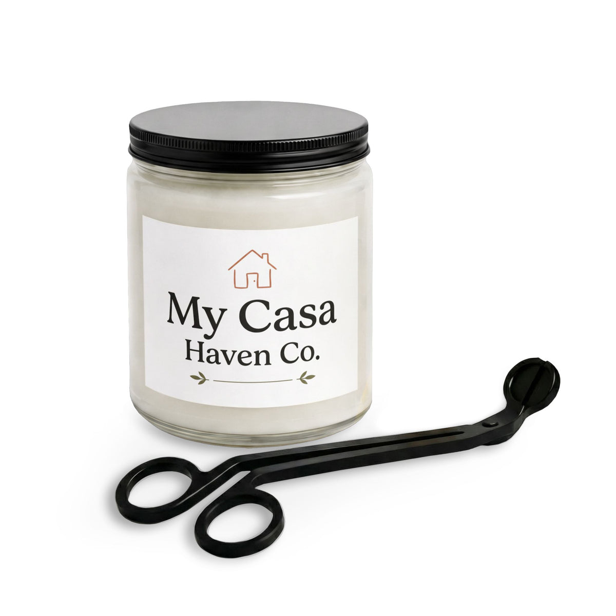 Candle jar with pale cream wax, clear glass sides, and black wick trimmer with loops